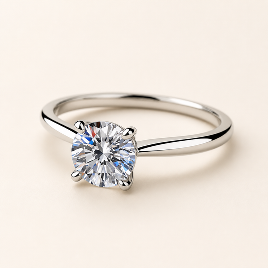Three-quarter studio view of a four-prong round moissanite solitaire ring