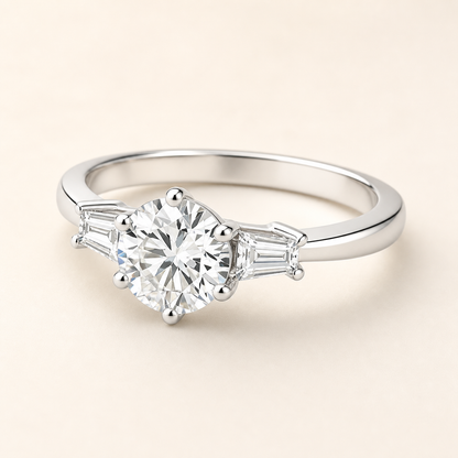Three-quarter studio view of a six-prong moissanite ring with tapered baguette side stones