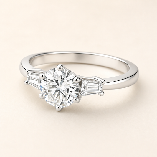 Three-quarter studio view of a six-prong moissanite ring with tapered baguette side stones