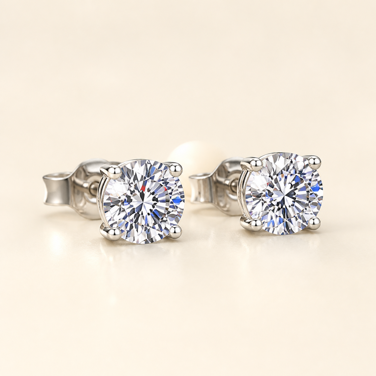 Three-quarter studio view of four-prong round moissanite stud earrings