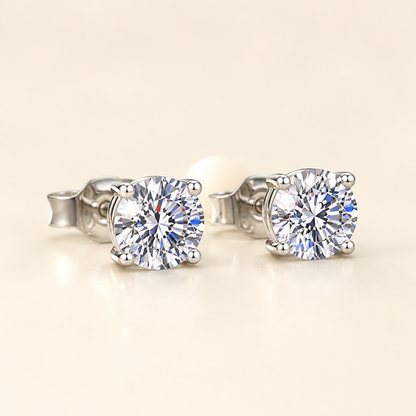 Three-quarter studio view of four-prong round moissanite stud earrings