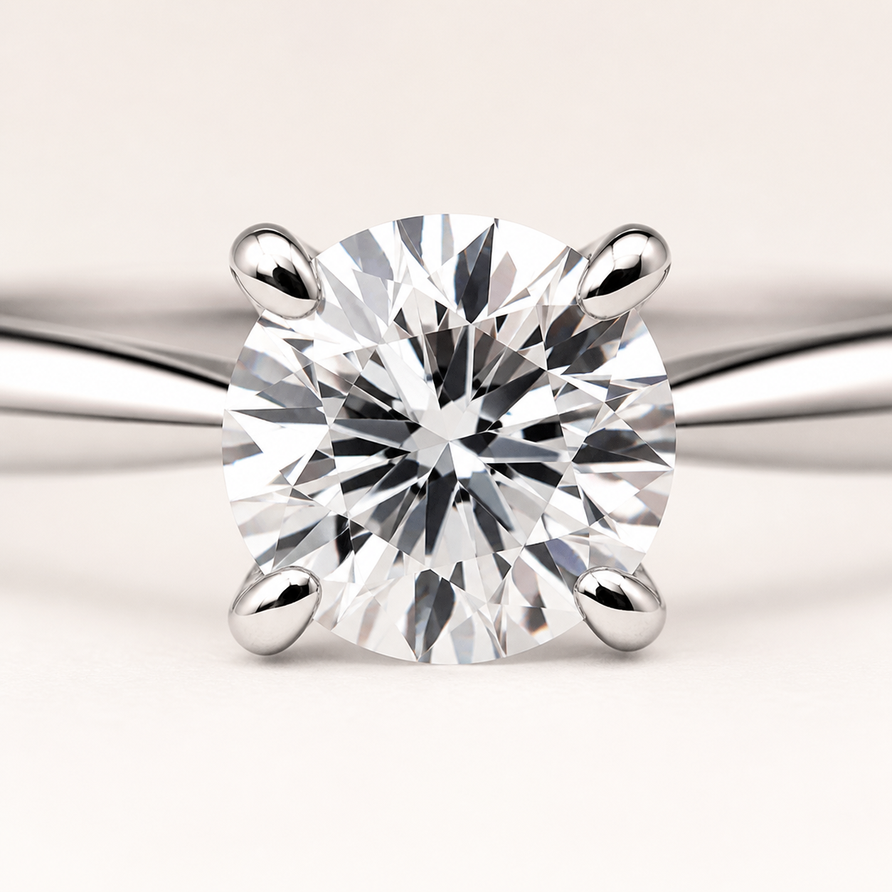 Macro detail showing the four-prong setting and round center stone