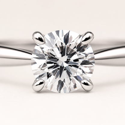 Macro detail showing the four-prong setting and round center stone