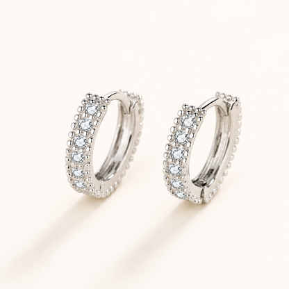 Pair of petite half-circle moissanite hoop earrings in polished silver