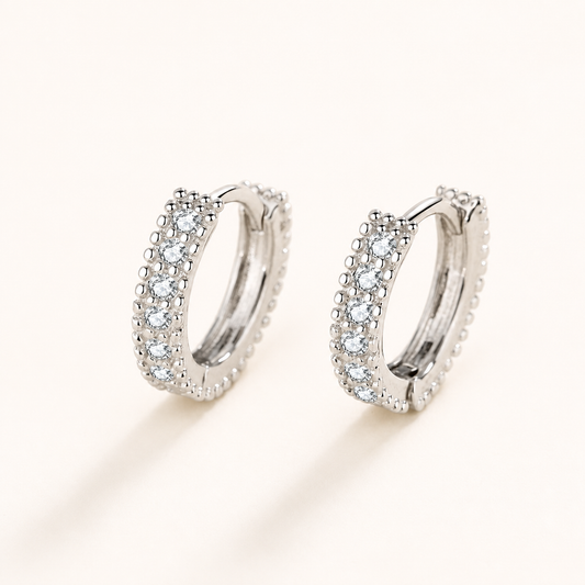 Pair of petite half-circle moissanite hoop earrings in polished silver