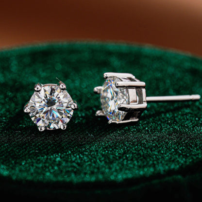 Angled view of classic six-prong round moissanite stud earrings
