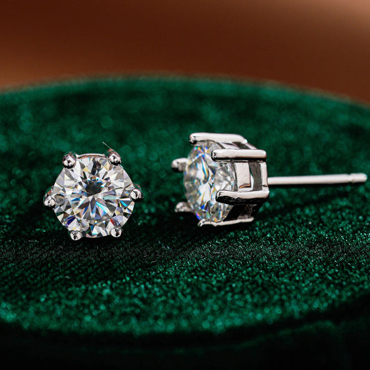 Angled view of classic six-prong round moissanite stud earrings
