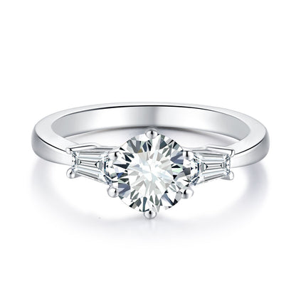 Six-prong round moissanite ring with tapered baguette side stones in silver