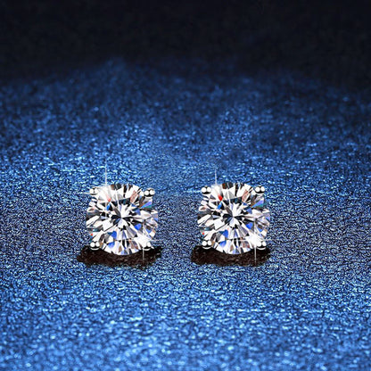 Pair of round moissanite stud earrings in minimal four-prong silver settings