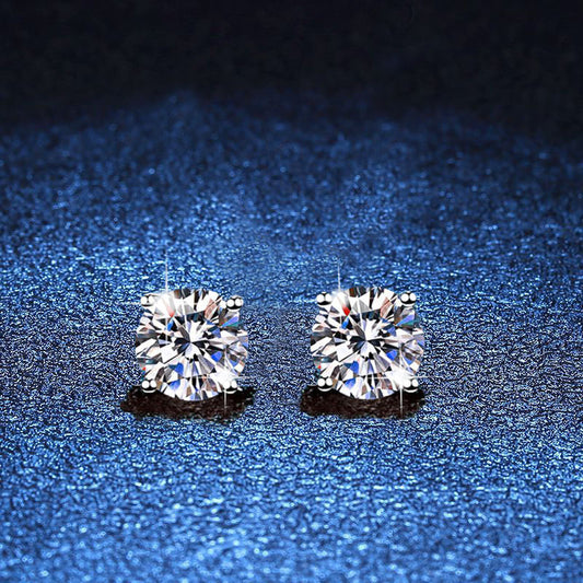Pair of round moissanite stud earrings in minimal four-prong silver settings