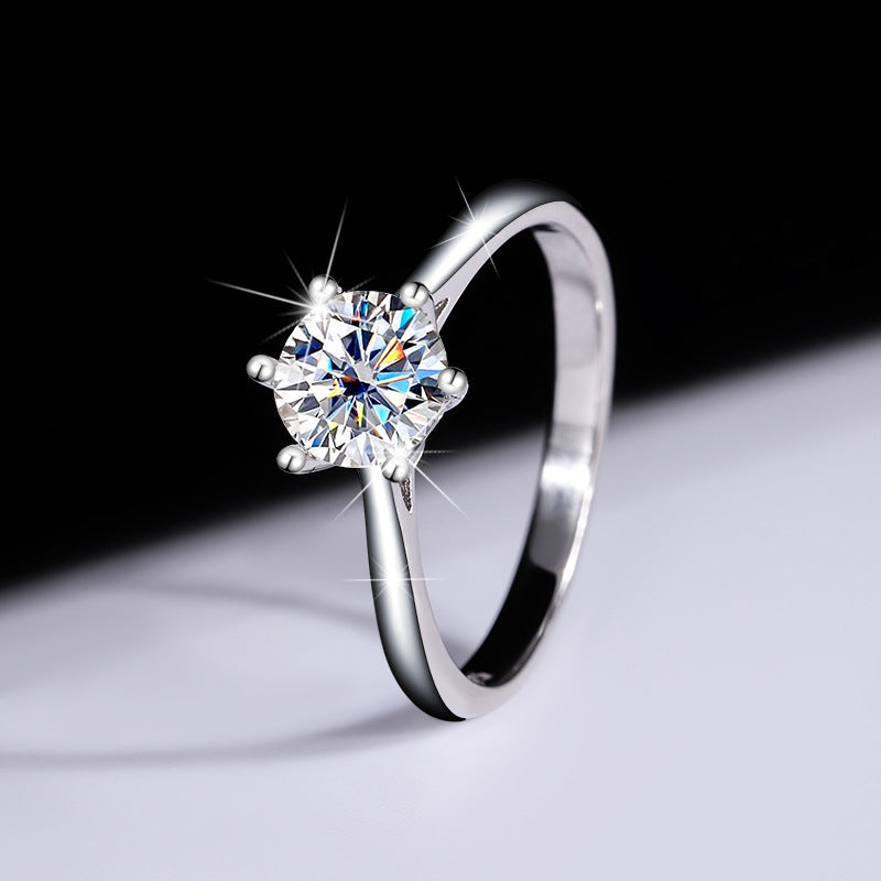 Profile view showing the open gallery of the six-prong moissanite ring