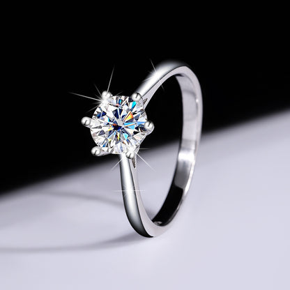 Profile view showing the open gallery of the six-prong moissanite ring