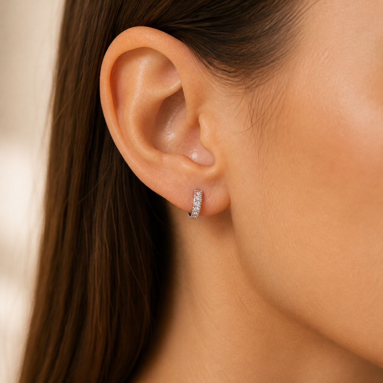 Gallery 2026 · Petite half-circle moissanite hoop worn on ear