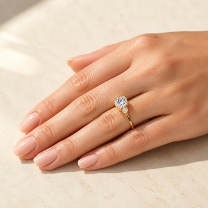 Gallery 2026 · Yellow gold three-stone ring worn on hand
