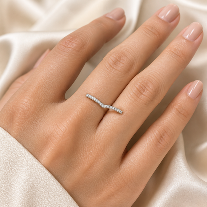 Gallery 2026 · V-shaped pavé wedding band worn on hand